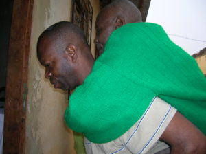 Emmanuel carrying papa on his back (2)